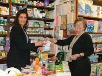 Customer, Mrs. Scott, choosing winning raffle ticket